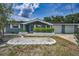 Charming home featuring a well-manicured lawn and attached garage at 5132 Flora Ave, Holiday, FL 34690