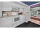 Efficient kitchen with white appliances, lots of storage, and counter space at 5132 Flora Ave, Holiday, FL 34690