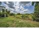 Picturesque vacant land with lush grass and a beautiful sky for development at 5132 Flora Ave, Holiday, FL 34690