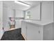 Bright, white laundry room with washer, dryer, sink, and ample storage space at 5132 Flora Ave, Holiday, FL 34690