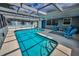 Sparkling screened-in pool area with seating offers a private outdoor oasis at 5132 Flora Ave, Holiday, FL 34690