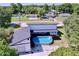 Aerial view of a home showcasing the large backyard, pool, deck, and surrounding neighborhood at 6158 Sumter Dr, Brooksville, FL 34602