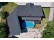 Aerial view of a home with a backyard featuring a private pool and well-maintained landscaping at 6158 Sumter Dr, Brooksville, FL 34602