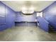Spacious unfinished basement with blue walls and concrete floors offers potential for customization at 6158 Sumter Dr, Brooksville, FL 34602