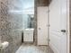 Bathroom with a sink, mirror, light fixture, and tiled walls and flooring at 6158 Sumter Dr, Brooksville, FL 34602