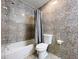 Bathroom with a gray shower curtain and matching tile walls and flooring at 6158 Sumter Dr, Brooksville, FL 34602