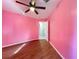 Bedroom featuring pink walls and wood flooring at 6158 Sumter Dr, Brooksville, FL 34602