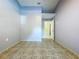 Bedroom featuring tile flooring, light-colored walls, and a doorway leading to another room at 6158 Sumter Dr, Brooksville, FL 34602