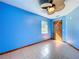 Bedroom featuring light blue walls, tile flooring, and a wooden door at 6158 Sumter Dr, Brooksville, FL 34602