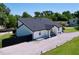 Aerial shot of white modern home with black roof and nice landscaping at 6158 Sumter Dr, Brooksville, FL 34602