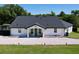 Charming one-story home with a new dark roof, white exterior, and a gravel front yard at 6158 Sumter Dr, Brooksville, FL 34602