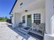 Charming covered front porch with seating area, perfect for relaxing outdoors at 6158 Sumter Dr, Brooksville, FL 34602