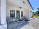 Inviting front porch area with seating and stylish green door framed by windows at 6158 Sumter Dr, Brooksville, FL 34602