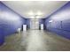Inside the spacious garage with a roll-up door, concrete floor, and painted blue walls at 6158 Sumter Dr, Brooksville, FL 34602