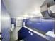 Wide angle interior shot of the garage featuring blue walls, and concrete floors at 6158 Sumter Dr, Brooksville, FL 34602