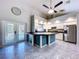 Bright kitchen featuring an island, stainless steel refrigerator, and French doors to the pool area at 6158 Sumter Dr, Brooksville, FL 34602