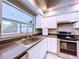 Modern kitchen with stainless steel appliances and a large window providing natural light at 6158 Sumter Dr, Brooksville, FL 34602