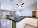 Open-concept living room with kitchen access, featuring tile flooring and plenty of natural light at 6158 Sumter Dr, Brooksville, FL 34602
