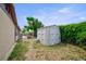 The spacious backyard includes a storage shed, patio with seating, and privacy fence at 6231 Westport Dr, Port Richey, FL 34668