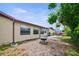 This home features a cozy backyard with seating, a fire pit, and mature trees at 6231 Westport Dr, Port Richey, FL 34668