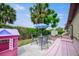 Enjoy outdoor living in this backyard featuring a patio, seating, and mature trees at 6231 Westport Dr, Port Richey, FL 34668