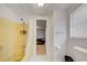 Bright bathroom features a yellow tiled shower with glass door and bright white tile floors at 6231 Westport Dr, Port Richey, FL 34668