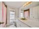 Bathroom with a marble countertop, classic fixtures, and large mirror at 6231 Westport Dr, Port Richey, FL 34668