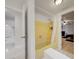 Bathroom showcases a yellow tiled shower, white tile floors, and access to the bedroom at 6231 Westport Dr, Port Richey, FL 34668
