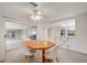 Bright dining area featuring a ceiling fan and sliding glass doors to a screened lanai at 6231 Westport Dr, Port Richey, FL 34668
