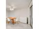 Bright dining area featuring tile floors, a ceiling fan and modern table at 6231 Westport Dr, Port Richey, FL 34668