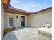 A covered front porch with a decorative door and a small seating area at 6231 Westport Dr, Port Richey, FL 34668
