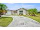 Attractive home showcasing mature tropical landscaping, a sunny lawn, and a spacious driveway at 6231 Westport Dr, Port Richey, FL 34668