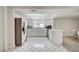 Open kitchen features stainless steel appliances, tile floors and white cabinets at 6231 Westport Dr, Port Richey, FL 34668