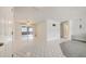 Spacious, light-filled living room featuring modern tile flooring and a sliding glass door at 6231 Westport Dr, Port Richey, FL 34668