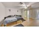 Bedroom featuring hardwood floors, ceiling fan, closet with mirrored doors, and ensuite bathroom at 6231 Westport Dr, Port Richey, FL 34668