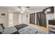 Bedroom features hardwood floors, ensuite bathroom, closet, and patio access with floor-to-ceiling curtains at 6231 Westport Dr, Port Richey, FL 34668