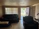 This living room includes tile floors, a front entrance, and large window at 6315 Hyperion Dr, Port Richey, FL 34668