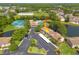 Aerial view showcasing the community's amenities, pond, parking, and lush green surroundings at 6508 Tina Dr # 14, New Port Richey, FL 34653