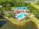 Overhead view highlighting the community pool, tennis courts, spa, and lake, creating a relaxing resort lifestyle at 6508 Tina Dr # 14, New Port Richey, FL 34653