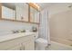 Bright bathroom featuring a large mirror, a vanity with sink, and a shower/tub combo with a patterned curtain at 6508 Tina Dr # 14, New Port Richey, FL 34653