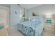 Comfortable bedroom featuring a queen-sized bed with blue patterned bedding, carpet, and ample closet space at 6508 Tina Dr # 14, New Port Richey, FL 34653