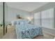 Cozy bedroom featuring a queen-sized bed with blue patterned bedding, carpet, and closet at 6508 Tina Dr # 14, New Port Richey, FL 34653