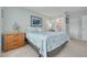 Bedroom featuring carpet, a window, a queen-sized bed with blue and white bedding and an ensuite bathroom at 6508 Tina Dr # 14, New Port Richey, FL 34653