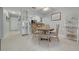 Dining area featuring a round wooden table with chairs, built-in display cabinet, and views into the kitchen at 6508 Tina Dr # 14, New Port Richey, FL 34653