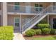 Inviting condo exterior with a staircase and well-manicured landscaping at 6508 Tina Dr # 14, New Port Richey, FL 34653