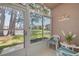 Relaxing lanai with lake view featuring tiled floors, comfortable seating, and sliding glass doors to enjoy the scenery at 6508 Tina Dr # 14, New Port Richey, FL 34653
