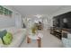 Open living space with tile flooring, white couch and chair, leading to the dining and kitchen areas at 6508 Tina Dr # 14, New Port Richey, FL 34653