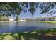 Picturesque pond with a fountain, offering a tranquil view of the surrounding residential buildings at 6508 Tina Dr # 14, New Port Richey, FL 34653
