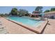 Community pool area with ample lounge seating, a clear blue pool, and surrounding greenery at 6508 Tina Dr # 14, New Port Richey, FL 34653