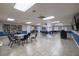 Bright recreation room with tile floors, bookshelves, and several tables with seating at 6508 Tina Dr # 14, New Port Richey, FL 34653
